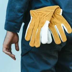 Close-Up of Mechanic Technician Hand and Leather Gloves While Standing in front of Maintenance Workshop, Technical Service Worker Preparation for Fixing Automotive in Workshops House. Mechanical Job